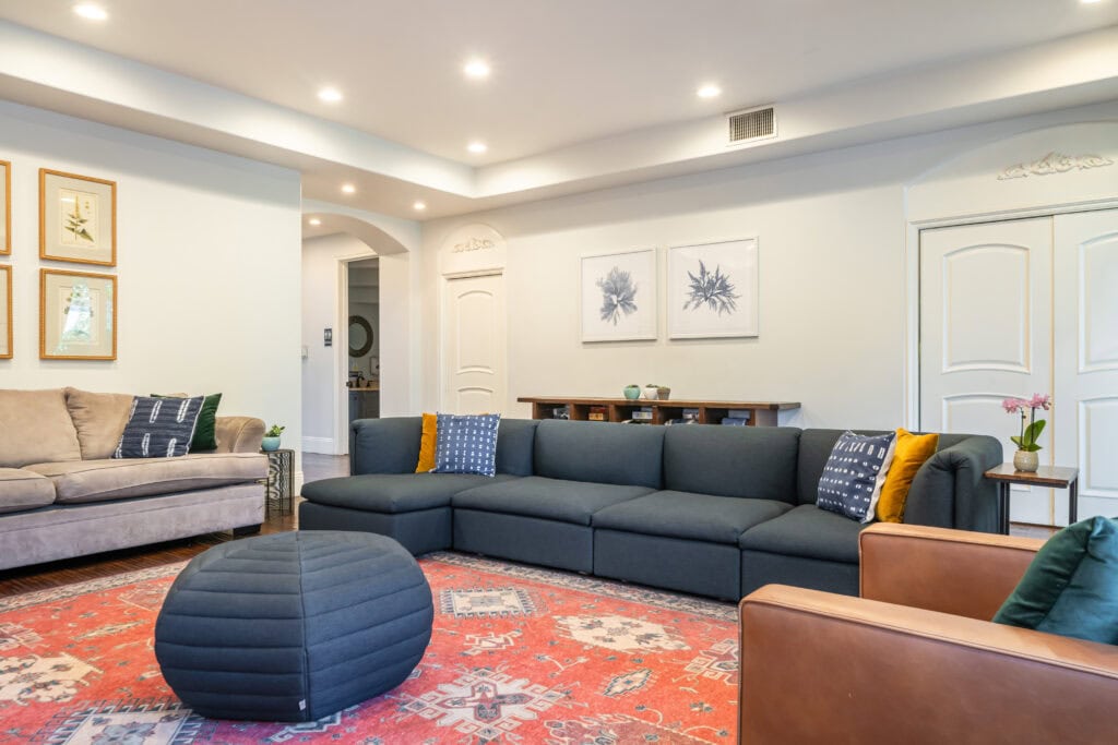 Bright living room with blue sofas at Cliffside West LA's Overland residence.
